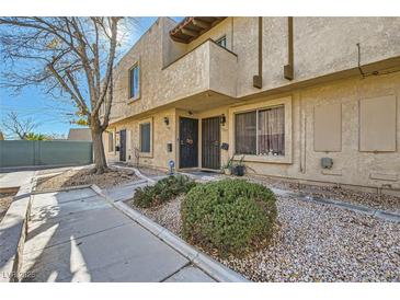 Inviting exterior of a two-story building with landscaping and walkways at 6381 W Washington Ave, Las Vegas, NV 89107