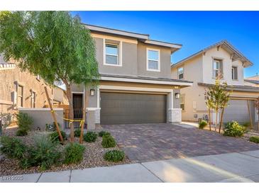 Two-story house with a two-car garage and landscaped front yard at 707 Cottonwood Hill Pl, Henderson, NV 89011