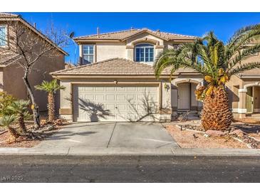 Two-story house with attached garage and landscaped yard at 7163 Brassica Ct, Las Vegas, NV 89148