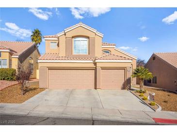 Two-story house with two-car garage and desert landscaping at 9700 Port Orange Ln, Las Vegas, NV 89134