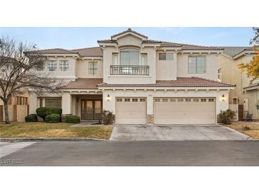 Two-story house with three-car garage, balcony, and landscaping at 10825 Bernini Dr, Las Vegas, NV 89141