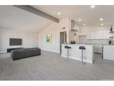 Open concept living room and kitchen with modern flooring and finishes at 1720 Hassett Ave, Las Vegas, NV 89104