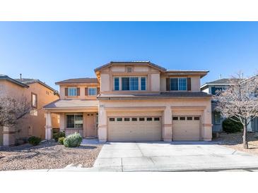 Two-story house with three-car garage and desert landscaping at 3107 Lenoir St, Las Vegas, NV 89135