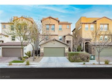 Three-story townhouses with attached garages and landscaping at 368 Gracious Way, Henderson, NV 89011