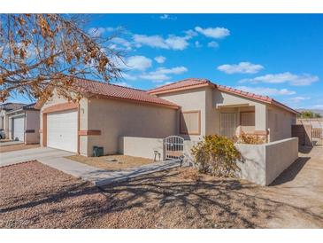 Single-story house with attached garage and desert landscaping at 402 Dune Ridge Ave, North Las Vegas, NV 89031