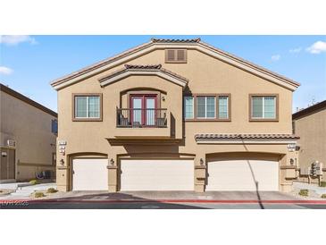 Tan two-story house with three-car garage and balcony at 4710 Frasers Owl Ave # 102, North Las Vegas, NV 89084