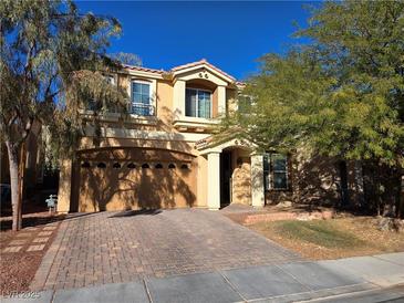 Two-story house with a three-car garage and landscaped yard at 6538 Creekside Cellars Ct, Las Vegas, NV 89139