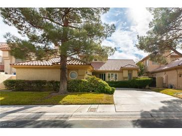 Charming single-story home with a tile roof, mature trees, and well-maintained landscaping at 7909 Rio Rico Dr, Las Vegas, NV 89113