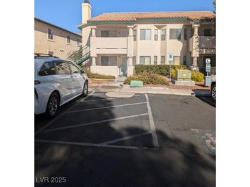 Two-story building exterior with parking and landscaping at 7964 Rim Rock Way # 102, Las Vegas, NV 89128