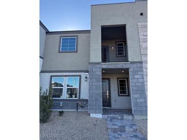 Modern two-story townhome with gray brick exterior and balcony at 127 Harmonica Ave # Lot 14, Henderson, NV 89011