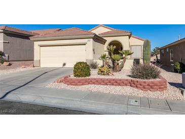 Single-story house with attached garage, landscaping, and desert plants at 1848 Mountain Ranch Ave Dr, Henderson, NV 89012