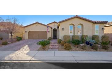 Charming one-story stucco home with a well-maintained lawn and a two-car garage at 2365 Boretto St, Henderson, NV 89044