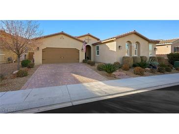 Single-story home with a two-car garage and landscaped front yard at 2365 Boretto St, Henderson, NV 89044