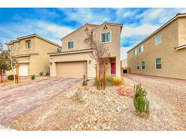 Two-story house with a landscaped front yard and attached garage at 5658 Adobe Jack St, North Las Vegas, NV 89031