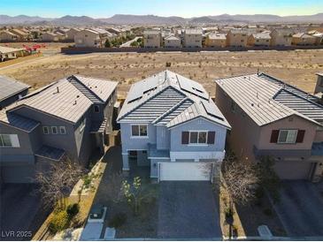 Aerial view of two-story house with solar panels and neighborhood in background at 5921 Roaring Canyon Ct, Las Vegas, NV 89139