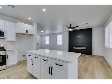 Modern kitchen with white cabinets, quartz countertops, and stainless steel appliances at 5934 Clear Valley Ave, Las Vegas, NV 89142