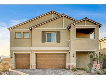 Two-story house with tan siding, brown garage doors, and a landscaped yard at 5969 Viscaya Grove St, Las Vegas, NV 89118