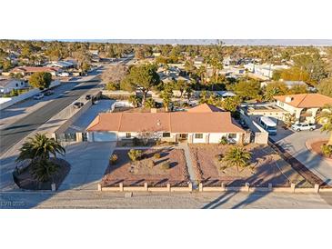 Single story home with landscaped yard and large driveway, aerial view at 6480 Darby Ave, Las Vegas, NV 89146