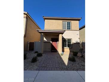 Two-story house with red door and landscaped yard at 7355 Sunray Point St, North Las Vegas, NV 89084