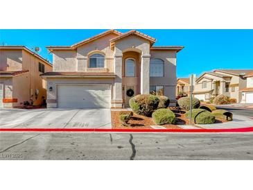 Two-story house with attached garage and landscaping at 8125 Caramel Gorge Ct, Las Vegas, NV 89143