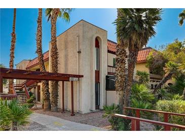 Spanish style condo building with palm trees and walkway at 3152 S Eastern Ave # 26, Las Vegas, NV 89169