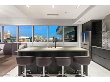 Modern kitchen with island, stainless steel appliances, and city views at 4471 Dean Matin Dr # 1210, Las Vegas, NV 89103