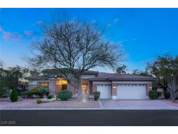 Beautiful brick home with mature landscaping and a three-car garage at 4649 Bird View Ct, Las Vegas, NV 89129