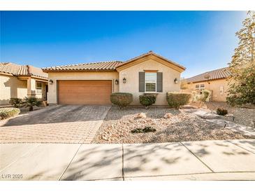 Single-story house with a two-car garage and well-manicured landscaping at 766 Topocoba St, Las Vegas, NV 89178