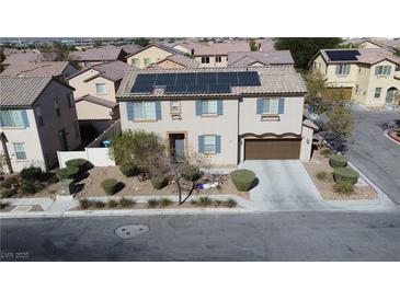 Two-story house with solar panels, driveway, and landscaping, in a residential neighborhood at 2404 Briggsdale Ave, North Las Vegas, NV 89081