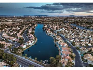 Aerial view of a lakefront community with numerous houses at 2617 Huber Heights Dr, Las Vegas, NV 89128