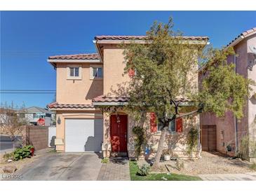 Two-story house with tan exterior, red door, and attached garage at 3728 Spiritual Way, Las Vegas, NV 89115