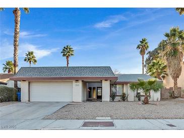 Single story home with a two-car garage and desert landscaping at 3849 Boca Chica Ave, Las Vegas, NV 89120