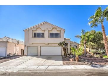 Two-story house with a two-car garage and palm trees at 4861 Camino Sombrero, North Las Vegas, NV 89031