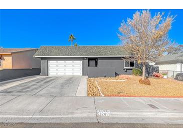 Ranch style home with attached garage and landscaped front yard at 5124 Brownwood Ave, Las Vegas, NV 89122