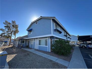 Light blue two-story building with parking and landscaping at 5320 Duralite St # 102, Las Vegas, NV 89122