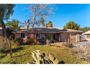 Ranch style home with mature landscaping and desert plants at 57 Marion Dr, Las Vegas, NV 89110