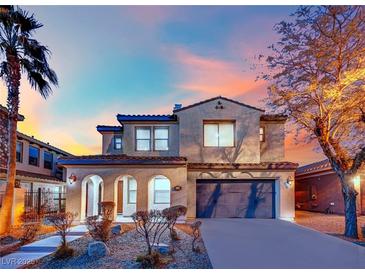 Two-story house with stucco exterior, arched entry, and attached garage at 624 Via Colmo Ave, Henderson, NV 89011