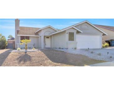 Newly painted single story home with a two car garage and desert landscaping at 823 Crabapple Dr, Henderson, NV 89002