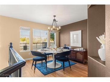 Bright dining room features a modern chandelier and seating for four at 8437 Sluman Ct, Las Vegas, NV 89128