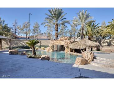 Resort-style pool with waterfall and tiki bar at 9113 Harvest Homes St, Las Vegas, NV 89123