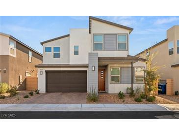 Two-story modern home with gray and brown accents, and a two-car garage at 3243 Fountaintree Ave, Henderson, NV 89044