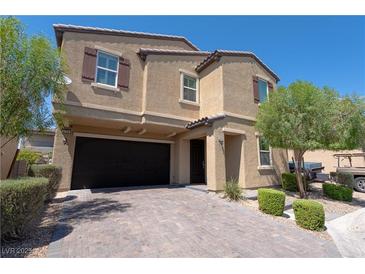 Two-story house with a black garage door and landscaped front yard at 6788 Lavender Sky Ct, Las Vegas, NV 89142