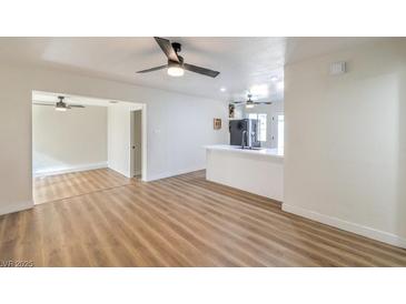 Bright living room with hardwood floors and ceiling fan at 1408 Palm St, Henderson, NV 89011