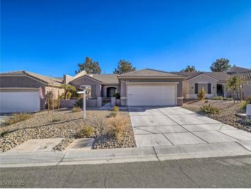 Charming single-story home featuring desert landscaping, a concrete driveway, and a two-car garage at 1510 Fieldbrook St, Henderson, NV 89052