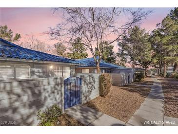 Front view of a charming house with blue accents and a walkway at 2132 Petersham Ct # D, Las Vegas, NV 89108