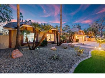 Beautiful desert landscaping surrounds this single-story home at dusk at 2228 Lucerne Ct, Henderson, NV 89014