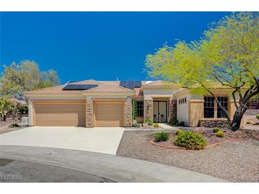 Single-story home with three-car garage, solar panels, and desert landscaping at 3004 Canton Hills St, Henderson, NV 89052