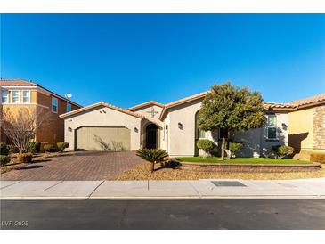 Single-story house with two-car garage, paver driveway, and landscaped front yard at 3158 Biancavilla Ave, Henderson, NV 89044