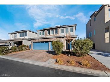 Three-car garage, stone accents, and landscaping highlight this inviting home exterior at 358 Terrill Ave, Las Vegas, NV 89183