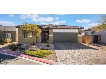 Single-story house with a two-car garage and landscaped front yard at 4509 Glossier Ave, North Las Vegas, NV 89084